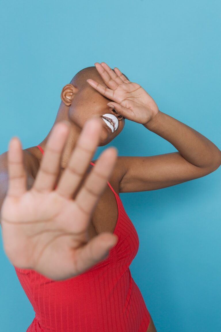 African American female holding out palm in stopping gesture