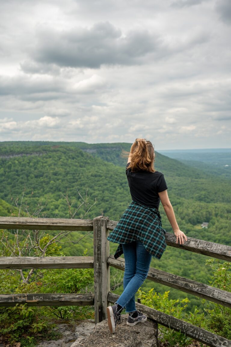 Woman Standing on a Stone at Observation Point Enjoying a Mountain Landscape View