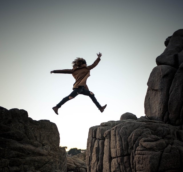 Woman jumping on big rock (2)